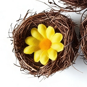 Handmade Easter wicker bird nest with a yellow daisy flower for festive decoration
