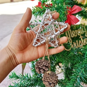 Silver rattan star Christmas ornament with natural pinecones and rustic hemp rope hanging detail