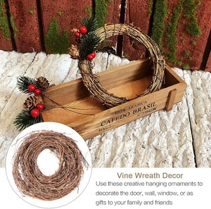 Natural vine wreath with pine cones and red berries for festive Christmas door decoration