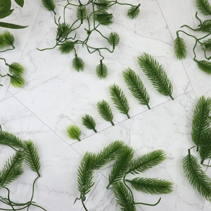 Artificial green pine needles and fir branches for Christmas DIY decor and floral crafts