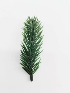 Close-up of artificial pine needles with realistic dark green PVC texture for DIY crafts