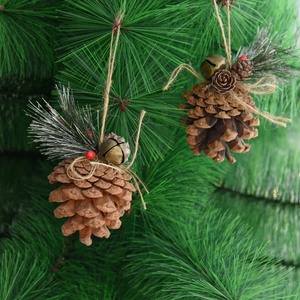 Christmas pine cone ornaments with red berries and silver needles on a festive tree branch