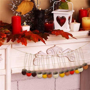 Felt acorn garland with twelve colorful wool nuts on twine for autumn mantel decoration
