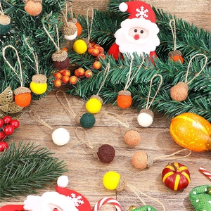 Close-up of handmade wool felt acorns in various colors with rustic hemp rope hangers