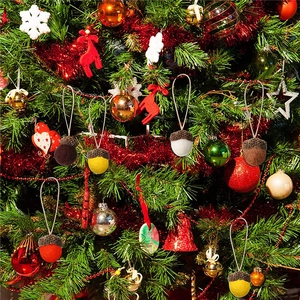 Colorful wool felt acorn Christmas ornaments hanging on a decorated festive pine tree