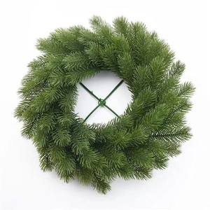 Close-up of a 4cm artificial green pine needle wreath with a central metal support frame