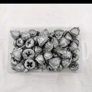 Eucalyptus dried fruits in silver finish inside a clear storage box on a plush rug