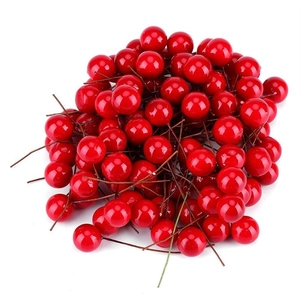 Macro detail of artificial glossy red berries with flexible brown stems for Christmas decor