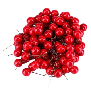 Glossy bright red artificial Christmas berries on stems for holiday tree decoration