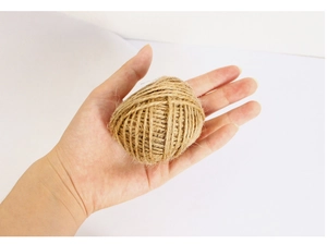 Detail of natural jute twine roll held by hand for DIY crafts and gift wrapping