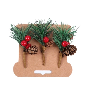 Christmas pine needle picks with red berries and pinecones for festive DIY gift box decor