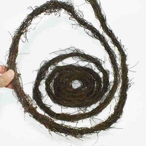 Close-up of hand holding dark brown natural vine twigs for rustic DIY wedding wreaths