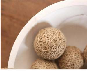 Natural jute rope decorative balls on wooden table for Christmas and home display