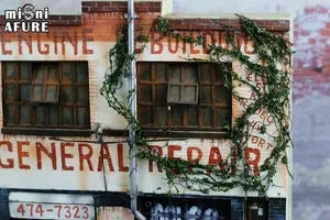 Miniature engine repair center model with red brick walls and vintage ivy details