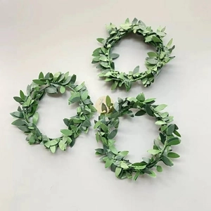Set of three sage green artificial leaf candle rings with realistic fabric textures