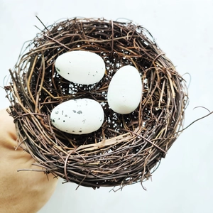 Artistic artificial bird nest with realistic twigs and spotted eggs for home decoration