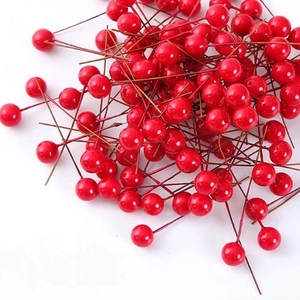 Vibrant red faux berries with glossy finish on brown stems for DIY Christmas wreaths