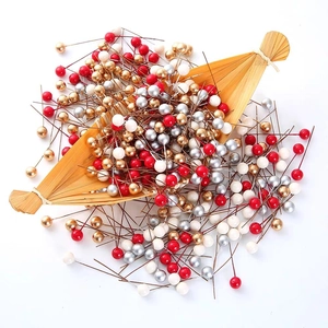 Colorful pearl head pins in red, gold, and silver for Christmas crafts and sewing