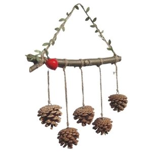 Rustic wall decoration featuring natural pine cones hanging from a wooden branch