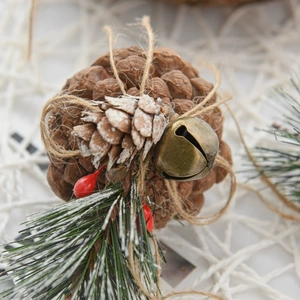 Christmas pine cone hanging ornament with red berries, pine needles and metal bell