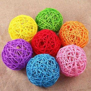 Top-down view of 8cm colorful woven rattan decorative balls on a burlap surface