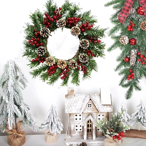 Christmas pine needle wreath with red berries and pine cones for festive holiday door decor