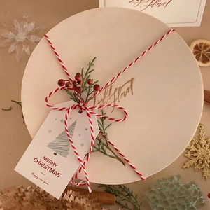 2mm red and white cotton twine on wooden Christmas gift box with pine and berries