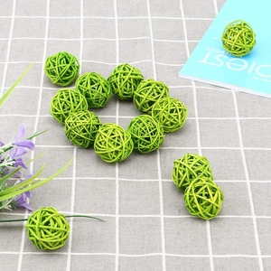 Green wicker rattan balls for Christmas party home decor on checkered tablecloth