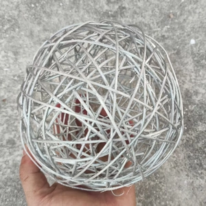 Macro detail of a 15cm silver woven rattan decorative ball with metallic finish