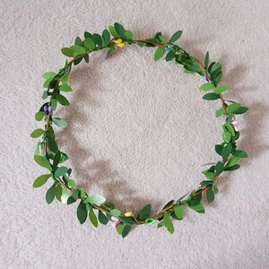 Close-up of leafy crown hairband with colorful berries for kids dance performances