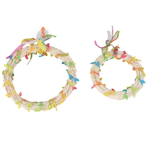 Detail of two handmade vine bird swings with colorful leaves and metal hanging hooks