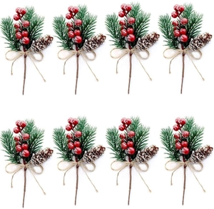 Detail of Christmas artificial pine picks with red berries, pine cones and twine bows