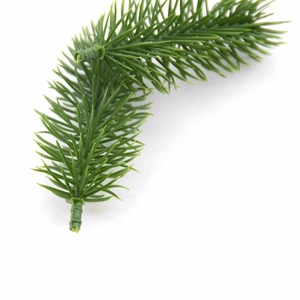 Close-up of 10cm artificial green pine branches for DIY Christmas tree and home decor