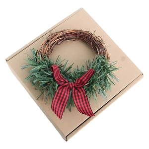 Christmas candle ring with red and black buffalo plaid bow and green pine on natural vine