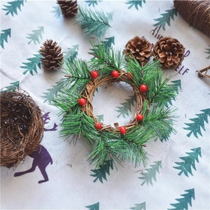 Christmas wreath with pine needles and red berries on a natural grapevine base decor