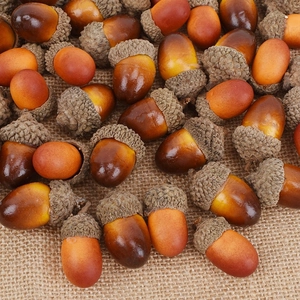 Realistic artificial acorns on burlap for festive autumn wreath and table decoration