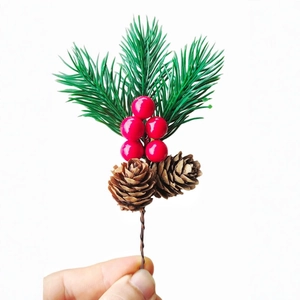 Artificial Christmas pine branch with red berries and pine cones for DIY decor
