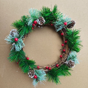 Detailed Christmas wreath with snowy pine needles, red berries, and natural pine cones