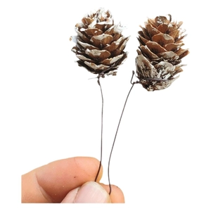 DIY Christmas frosted pine cones with white snow coating and wire stems for holiday decor
