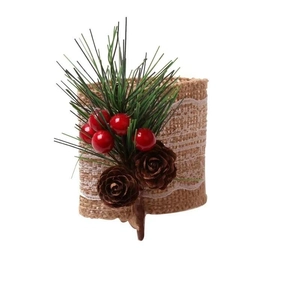 Christmas napkin ring with red berries, pine needles, and jute lace ribbon on white background