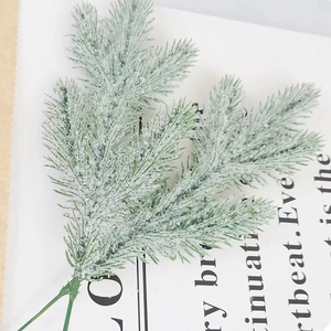 Artificial cedar branches with snow frosting for Christmas tree decoration and winter floral