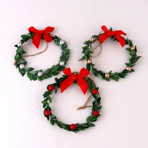 Set of three Christmas wreaths with red silk bows and colorful festive ornaments