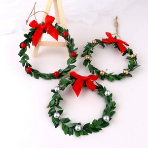 Set of three Christmas wreaths with red, gold, and silver berries on white background