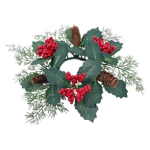 Christmas candle ring wreath with holly leaves, red berries, pine cones and needles