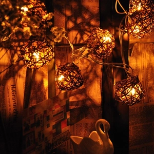 Retro rattan ball LED string lights with warm white glow for cozy home decor and party lighting