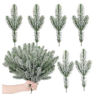 Close-up of artificial pine needles with white flocked snow for Christmas DIY crafts