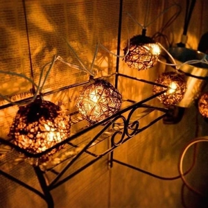 Handcrafted rattan ball string lights with warm yellow glow for vintage home decoration