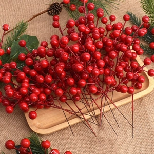 Artificial red holly berries stems for festive Christmas and New Year decorations