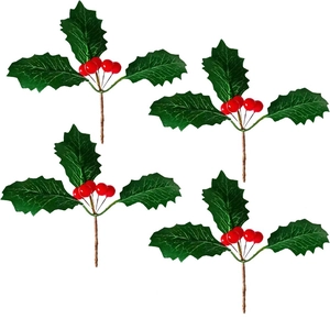 Artificial Christmas holly berries with green leaves and red berries on a white background