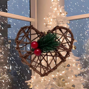 Handcrafted heart-shaped rattan ornament with red berries and pine needles for Christmas